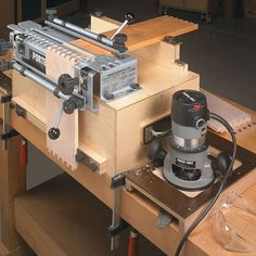 a router being worked on in a woodworking shop with other tools around it