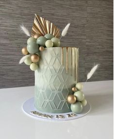 a cake decorated with gold and green decorations