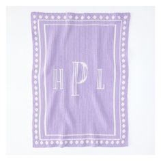 a purple and white towel with the letter p on it's front, sitting against a white background