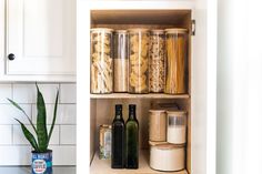 an open cabinet with spices and other items