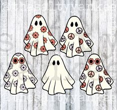 four ghost cut outs with flowers on them