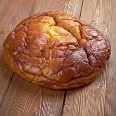 a loaf of bread sitting on top of a wooden table