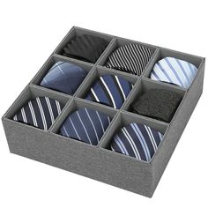 a box filled with different types of ties in it's storage compartment, on top of a white background