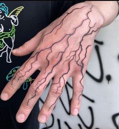 a person with tattoos on their hands and fingers