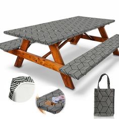 the picnic table is made from wood and has black and white patterned fabric on it