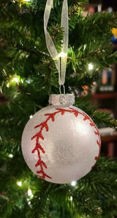 a baseball ornament hanging from a christmas tree