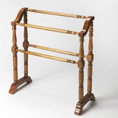 an old wooden rack with three bars on it's sides and two legs in the middle