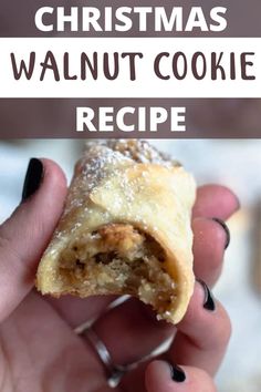 a person holding a pastry in their hand with the words christmas walnut cookies on it