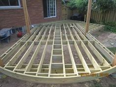 a wooden deck being built in front of a house