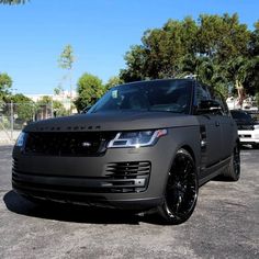 a grey range rover parked in a parking lot