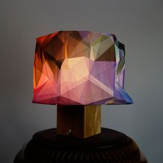 a colorful lamp sitting on top of a wooden table