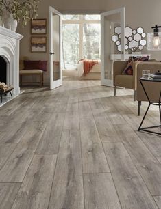 a living room with wood flooring and furniture