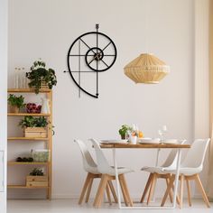 a dining room table with white chairs and a clock on the wall above it,