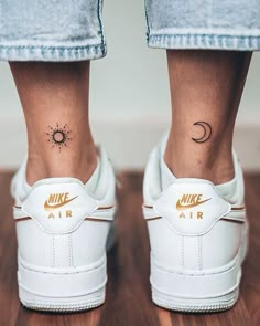 a woman's foot with a tattoo on her left ankle and the word air written in gold ink