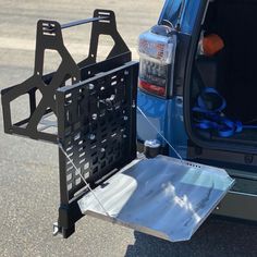 the back end of a blue van with its cargo compartment open and tools in it