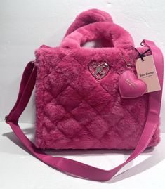 This Juicy Couture tote bag is the perfect accessory for any occasion. With a wide rectangular shape and double handles, it is easy to carry and provides ample space with its large size. The bag features a zip closure and a detachable strap, making it convenient for travel, casual outings, or business meetings. The pink exterior is adorned with faux leather and velvet accents, giving it a designer and luxurious feel. The interior is lined with beige and black logo polyester and canvas, and it comes with inner pocket for added organization. With a solid pattern and strap accent, this tote bag is a must-have for any fashion-forward woman. Pink Tote Bag, Velvet Accents, Pink Tote Bags, Couture Bags, Juicy Couture Bags, Pink Tote, Black Logo, Solid Pattern, Pink Bag