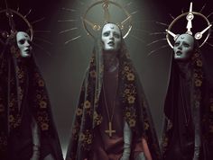 three creepy looking women with crosses on their heads