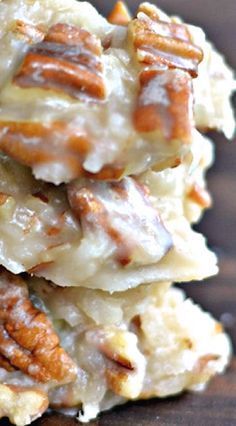 a stack of cookies with pecans on top