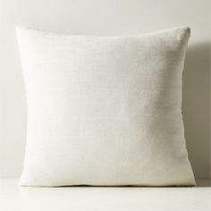 a white pillow sitting on top of a table