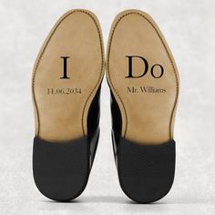 a pair of black shoes with i do written on the soles and back side