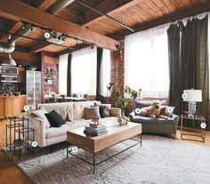 a living room filled with furniture and lots of windows