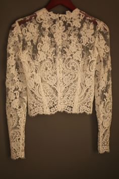 a white lace jacket hanging on a wall