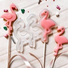 pink flamingo cake toppers on a white table