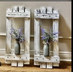 two wooden frames holding vases with flowers in them