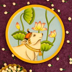 a decorative plate with a painting of a dog on it's face and flowers in the background