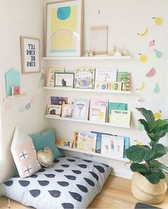 a child's room with bookshelves and toys on the shelves above it