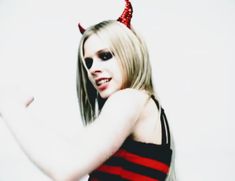 a woman dressed as a devil with horns on her head