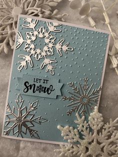 a card with snowflakes and the words let it snow