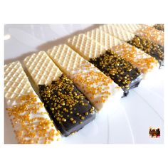 some kind of dessert with gold sprinkles on it's sides and white wafers in the middle