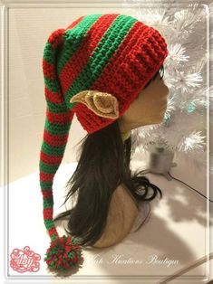 a woman's head wearing a red, green and white knitted christmas hat