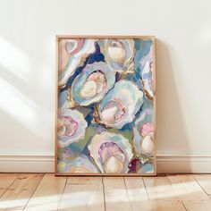 an abstract painting is displayed on the wall in front of a wooden floor and white walls