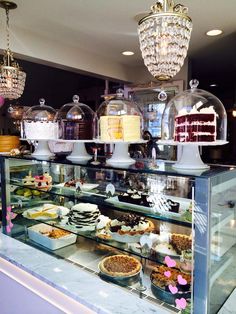 a display case filled with lots of cakes and desserts