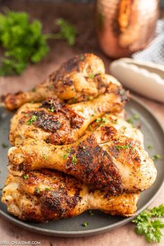 grilled chicken wings on a plate with parsley sprinkled around the edges