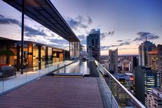 a balcony overlooking the city skyline at dusk