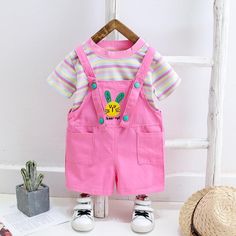 2-piece Colorful Striped T-shirt & Dungarees for Toddler Girl Wholesale children's clothing - PrettyKid Pink Cotton School Sets, Summer Cotton School Sets, Summer School Cotton Sets, Playful Pink School Sets, Pink Summer School Sets, Summer School Sets With Short Sleeves, Cute Pink Sets With Short Sleeves, Pink Short Sleeve School Sets, Pink Summer School Tops