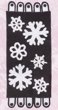 a black and white snowflaked design on a pink background with some scissors