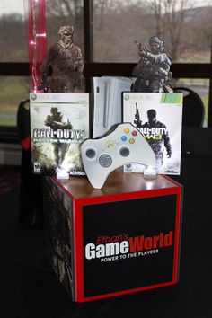 a video game console sitting on top of a table next to two figurines