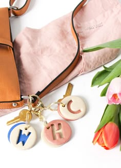 the purse is next to some flowers and keys