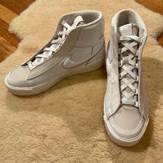 A Cute Pair Of White High Top, Partial Leather Tennis Shoes With 1.5” Platform. New In Box. Smoke-Free Home. Women’s Size 9.5. Nike Blazer Mid Victory, Shoes Nike Blazer, Leather Tennis Shoes, High Top Tennis Shoes, White High Tops, Nike Blazer Mid, Nike Blazers Mid, Blazer Mid, Nike Blazer