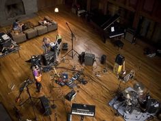 a group of people in a room with musical equipment