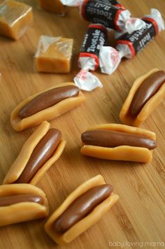 some hotdogs and candy on a wooden table