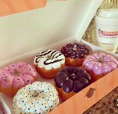 a box filled with lots of different flavored donuts