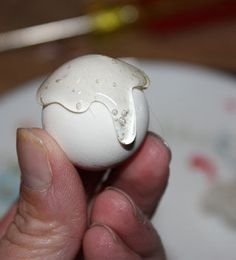 a person holding an egg in their hand