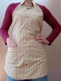 a woman standing with her hands on her hips and wearing an apron over her shoulder