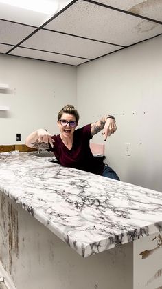 a man sitting on top of a marble counter