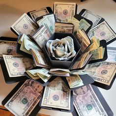 an origami flower made out of dollar bills